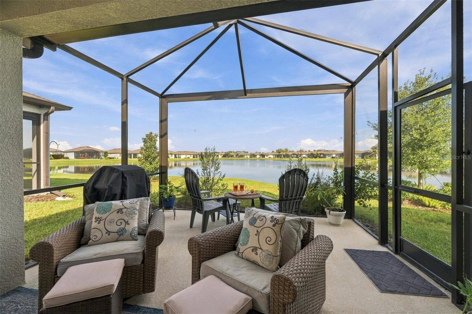 9260 BALLASTER POINTE LOOP, Parrish, FL 34219 Extra living space under the covered porch and grow your favorite plants in the open lanai.
