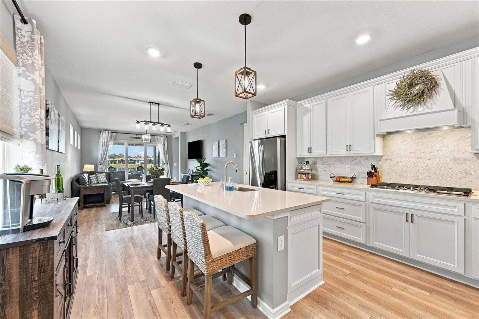 9260 BALLASTER POINTE LOOP, Parrish, FL 34219 This fabulous Kitchen comes furnished with cushion Bar stools, Coffee Bar and Dining Table for four.
