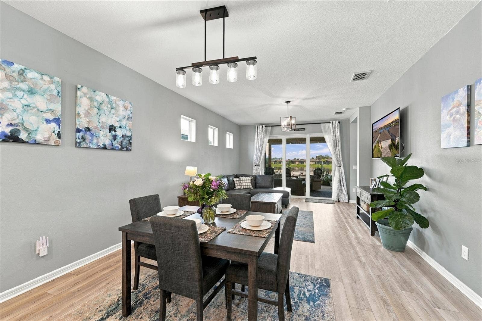 9260 BALLASTER POINTE LOOP, Parrish, FL 34219 Dining open to the Family Room.. Updated lighting throughout the home.
