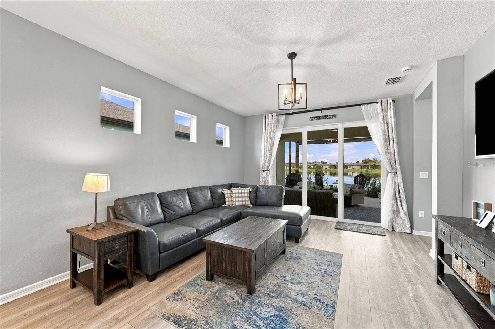 9260 BALLASTER POINTE LOOP, Parrish, FL 34219 Family Room Views with patio doors closed.