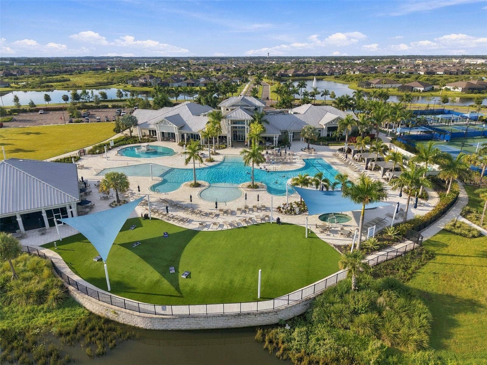 9260 BALLASTER POINTE LOOP, Parrish, FL 34219 Del Webbs incredible amentities include this Game Green, Hot Tub, Amzing Pool Deck and Club House.