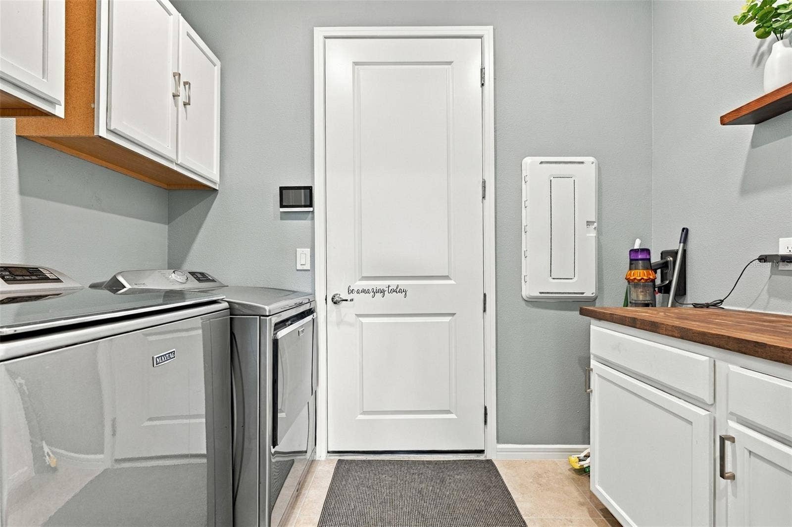 9260 BALLASTER POINTE LOOP, Parrish, FL 34219 Top of the line Washer and Dryer, wall and cabinet storage in this well appointed furnished laundry room.