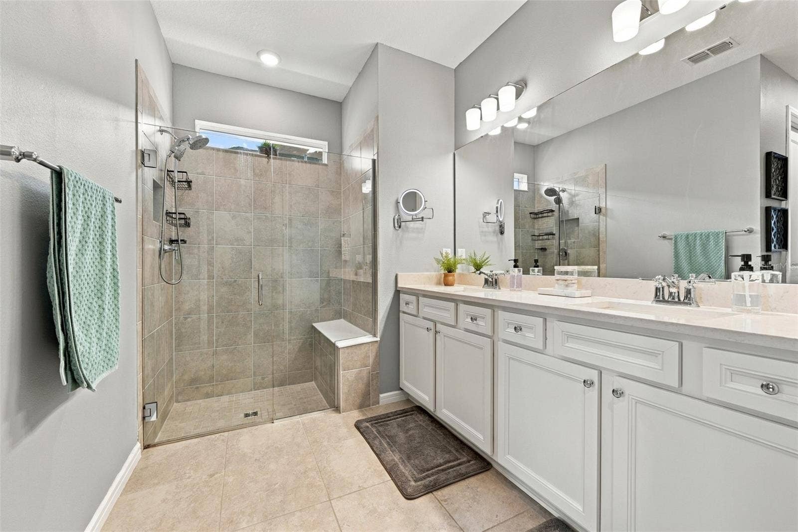 9260 BALLASTER POINTE LOOP, Parrish, FL 34219 Primary ensuite luxurious bathroom with spacious vanity and multiple shower heads and shower bench.