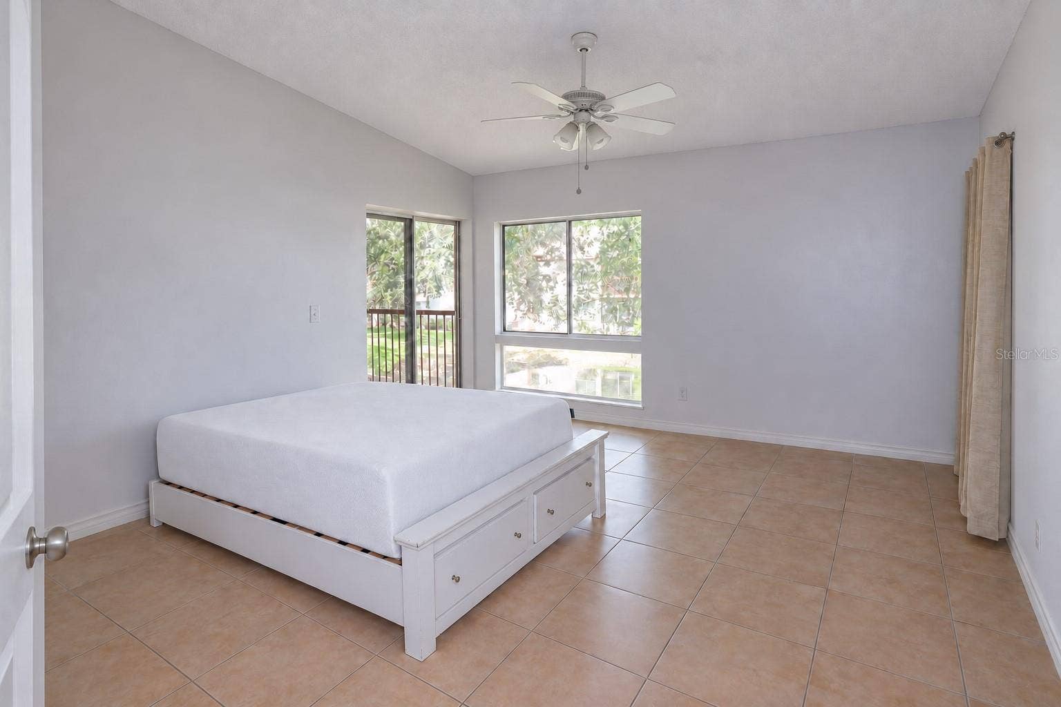 2527 CITRUS CLUB LANE, #3904, Orlando, FL 32839 Bedroom 2 with pond view and slider access to balcony. One closet at right; a second one left of the entry door.