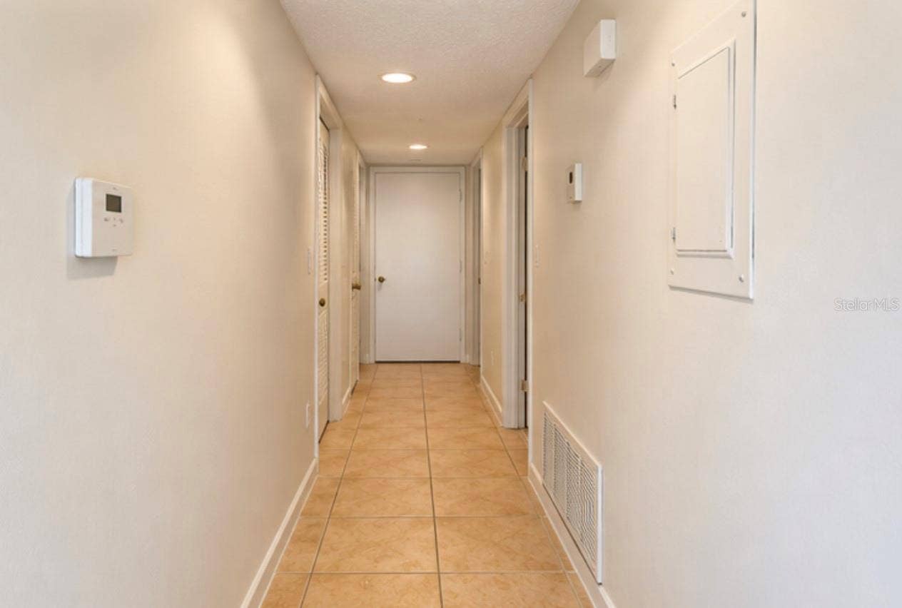 2527 CITRUS CLUB LANE, #3904, Orlando, FL 32839 Hallway to bedrooms; laundry closet at far end right.