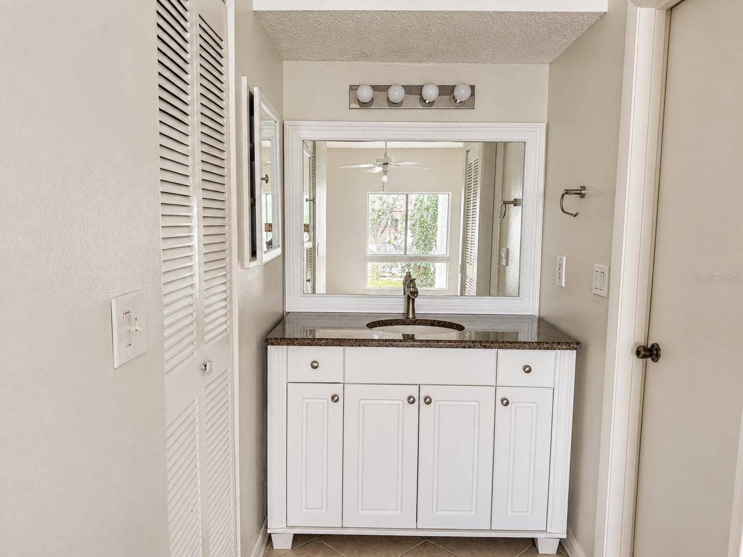 2527 CITRUS CLUB LANE, #3904, Orlando, FL 32839 Updated primary vanity area; walk-in closet at left. Shower and toilet area at right.