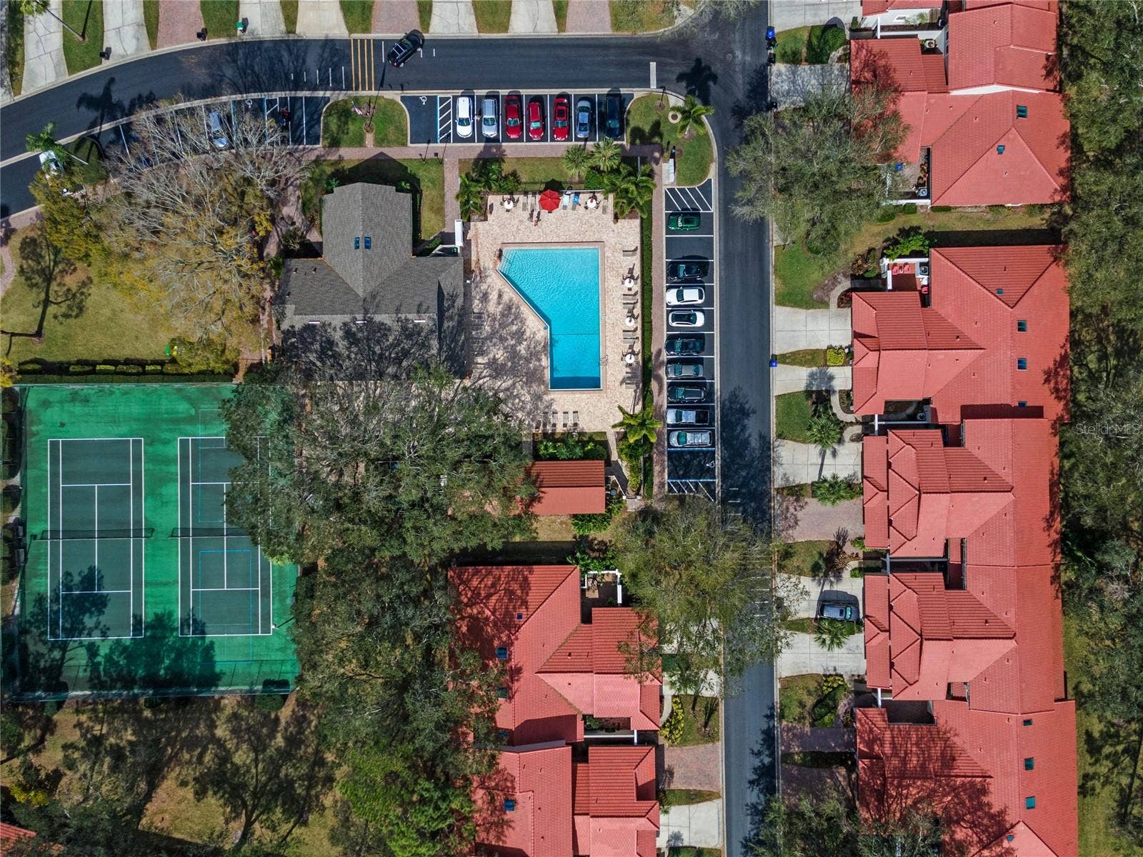 8235 AMBROSE COVE WAY, Orlando, FL 32819 Community recreation areas with tennis courts and space for outdoor games.