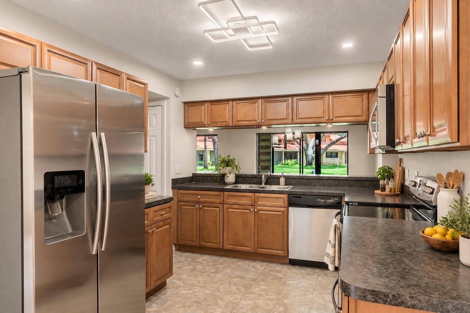 8235 AMBROSE COVE WAY, Orlando, FL 32819 Stainless steel appliances and a practical kitchen layout.