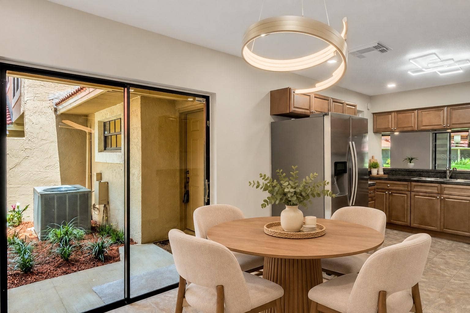 8235 AMBROSE COVE WAY, Orlando, FL 32819 Casual dining area beside the kitchen with sliding-door access outdoors.