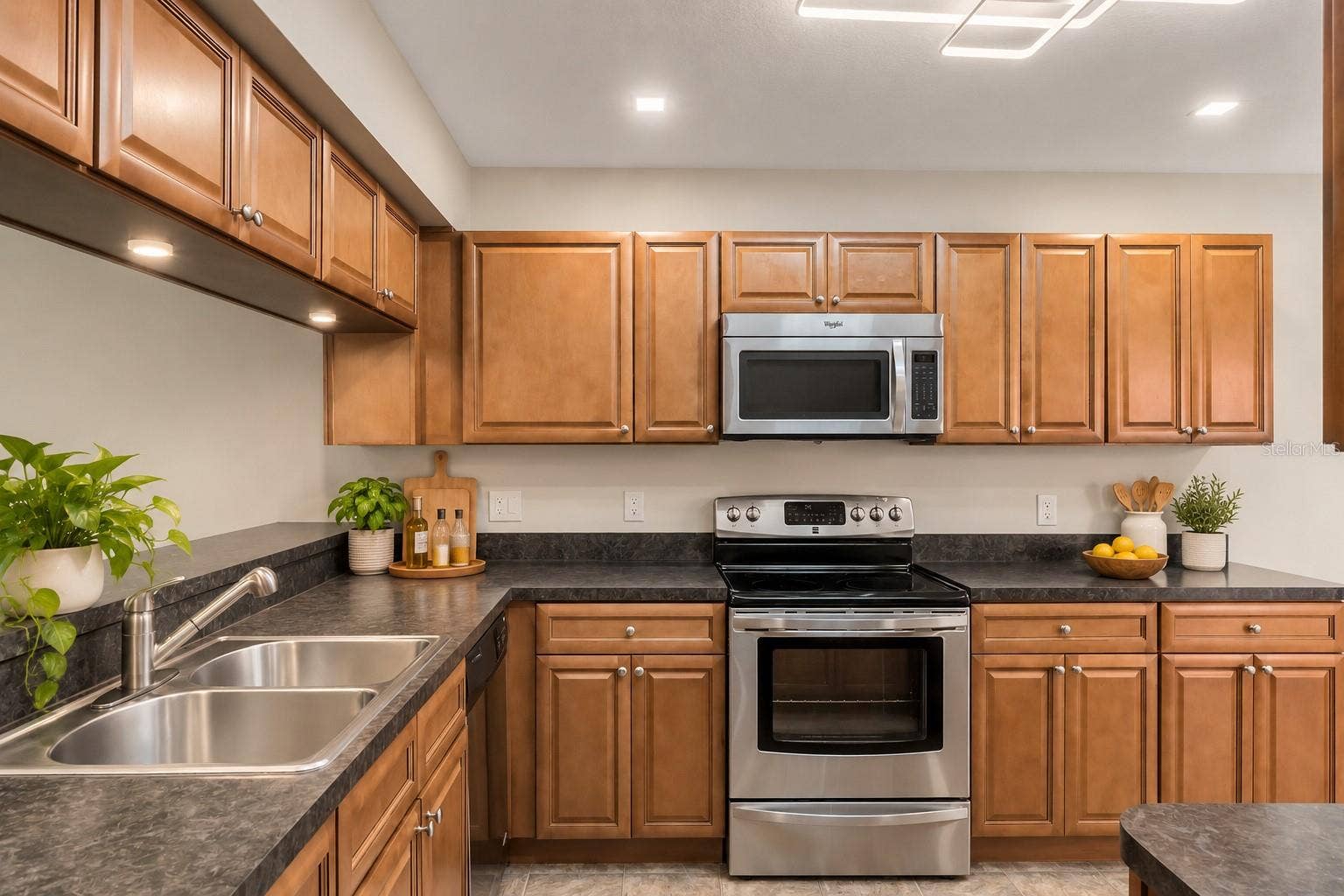 8235 AMBROSE COVE WAY, Orlando, FL 32819 Ample cabinetry and counter space for everyday meal preparation