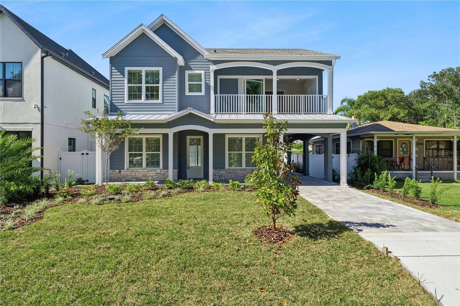 3456 FAIRWAY LANE, Orlando, FL 32804 Welcoming front exterior with gabled rooflines, a covered porch, and an upper-level balcony.
