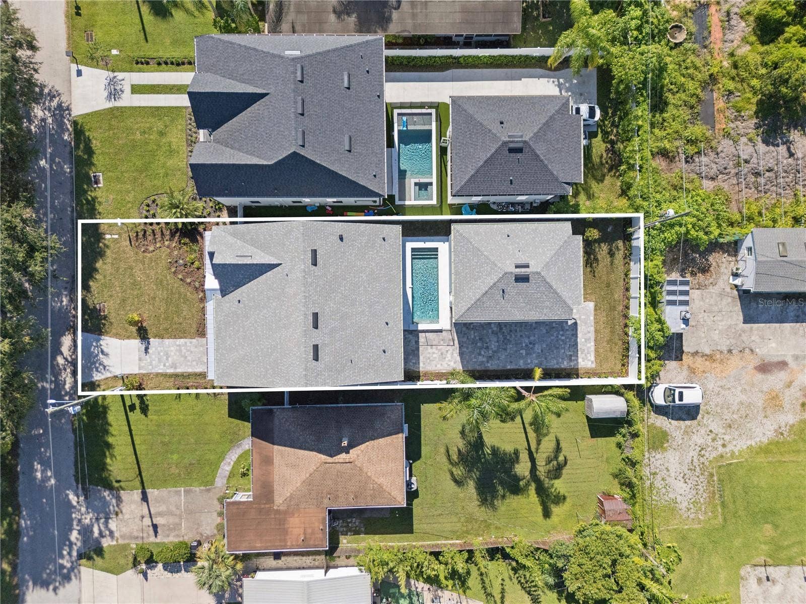 3456 FAIRWAY LANE, Orlando, FL 32804 An overhead view shows the home, pool, and rear garage; neighboring properties are also pictured.