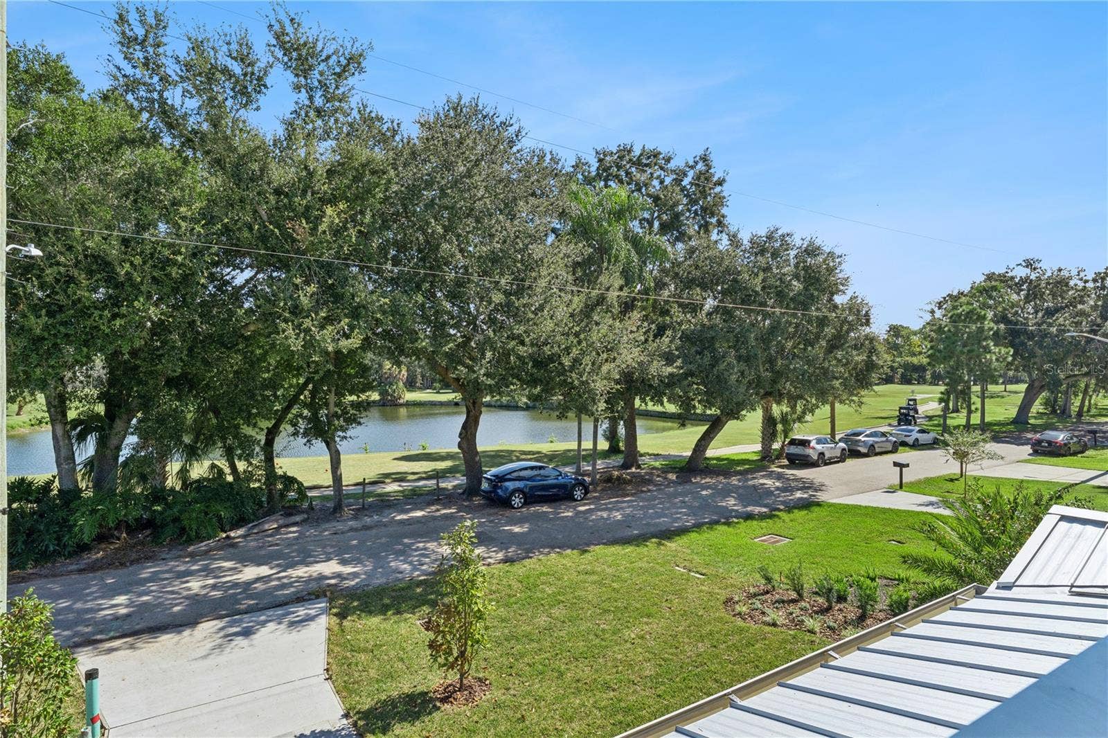 3456 FAIRWAY LANE, Orlando, FL 32804 An upper-level outlook takes in the pond and trees across the street.