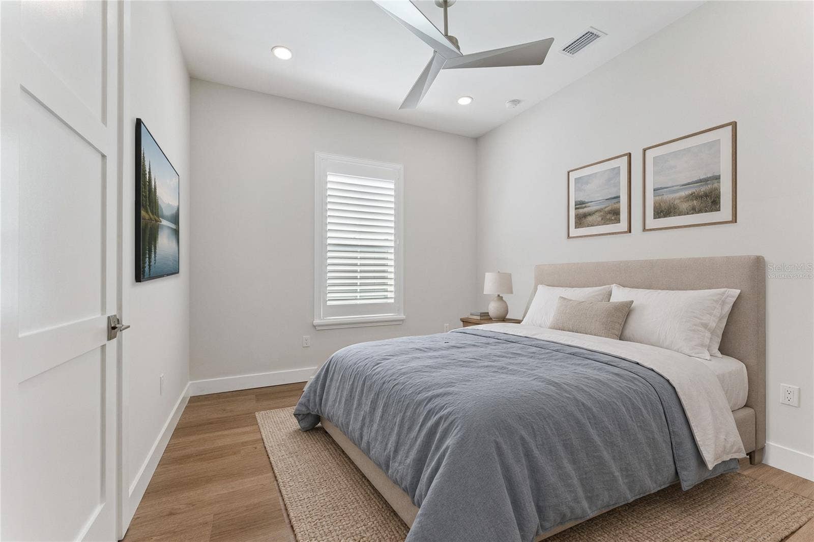 3456 FAIRWAY LANE, Orlando, FL 32804 Virtually Staged - This bedroom features a white ceiling fan, shuttered window, and light finishes.