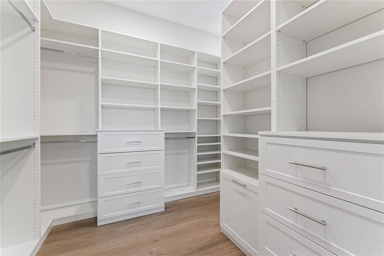 3456 FAIRWAY LANE, Orlando, FL 32804 Built-in shelves, drawers, and hanging rods provide organized closet storage.