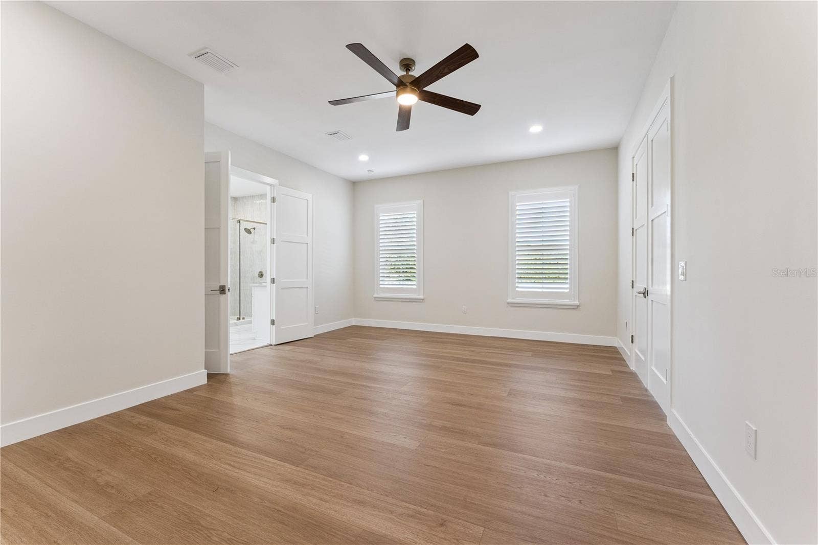 3456 FAIRWAY LANE, Orlando, FL 32804 A second view of the primary bedroom shows its windows and open floor space.