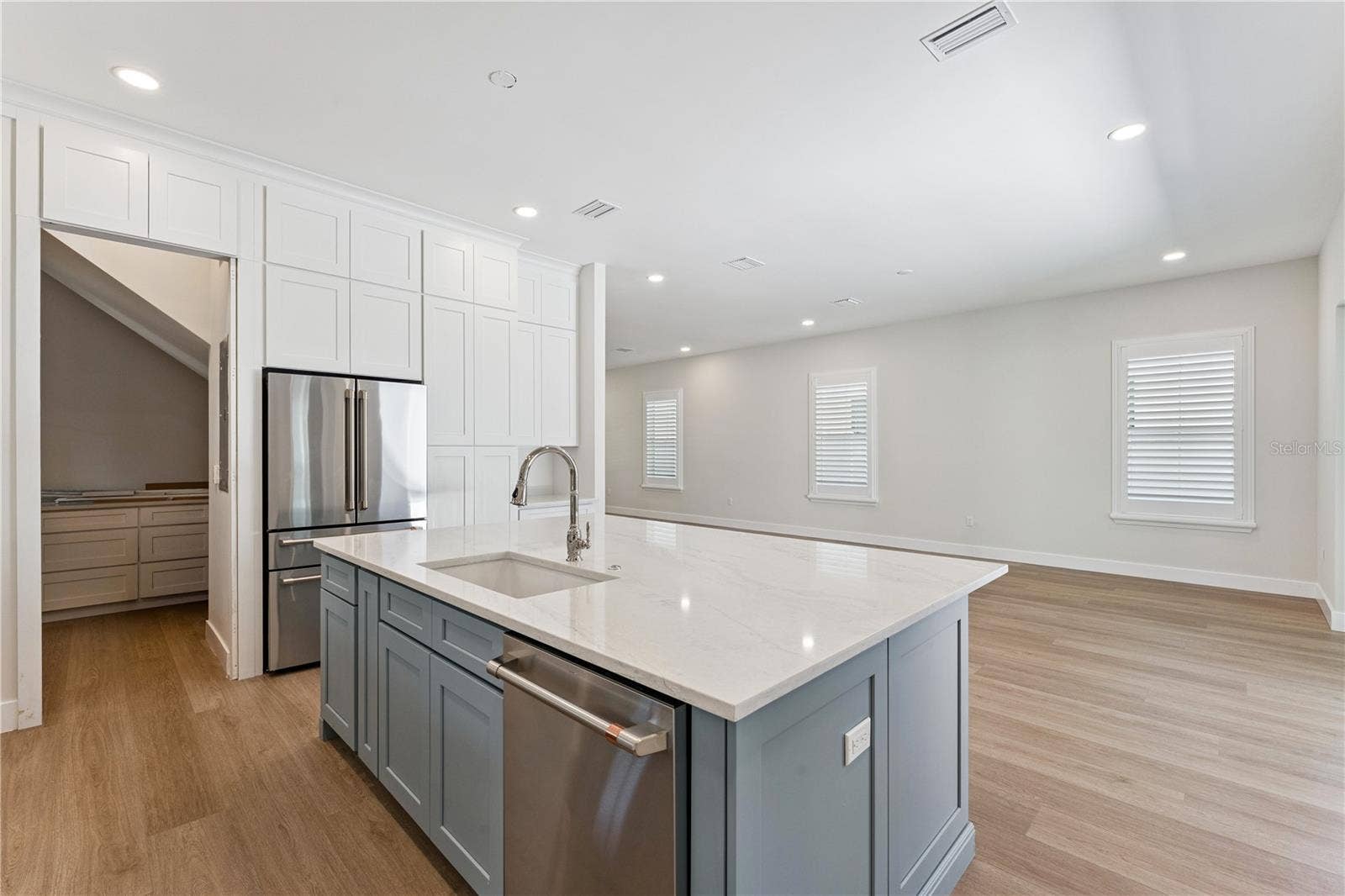 3456 FAIRWAY LANE, Orlando, FL 32804 A closer view of the blue kitchen island highlights the sink, dishwasher, and surrounding cabinetry.