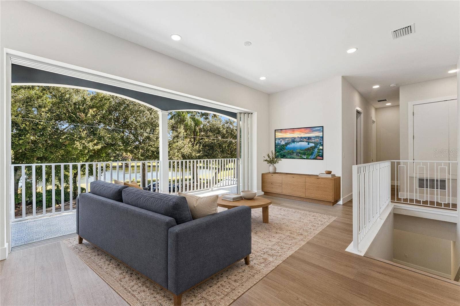 3456 FAIRWAY LANE, Orlando, FL 32804 Virtually Staged - The loft offers natural light, recessed lighting, and a view of the staircase.