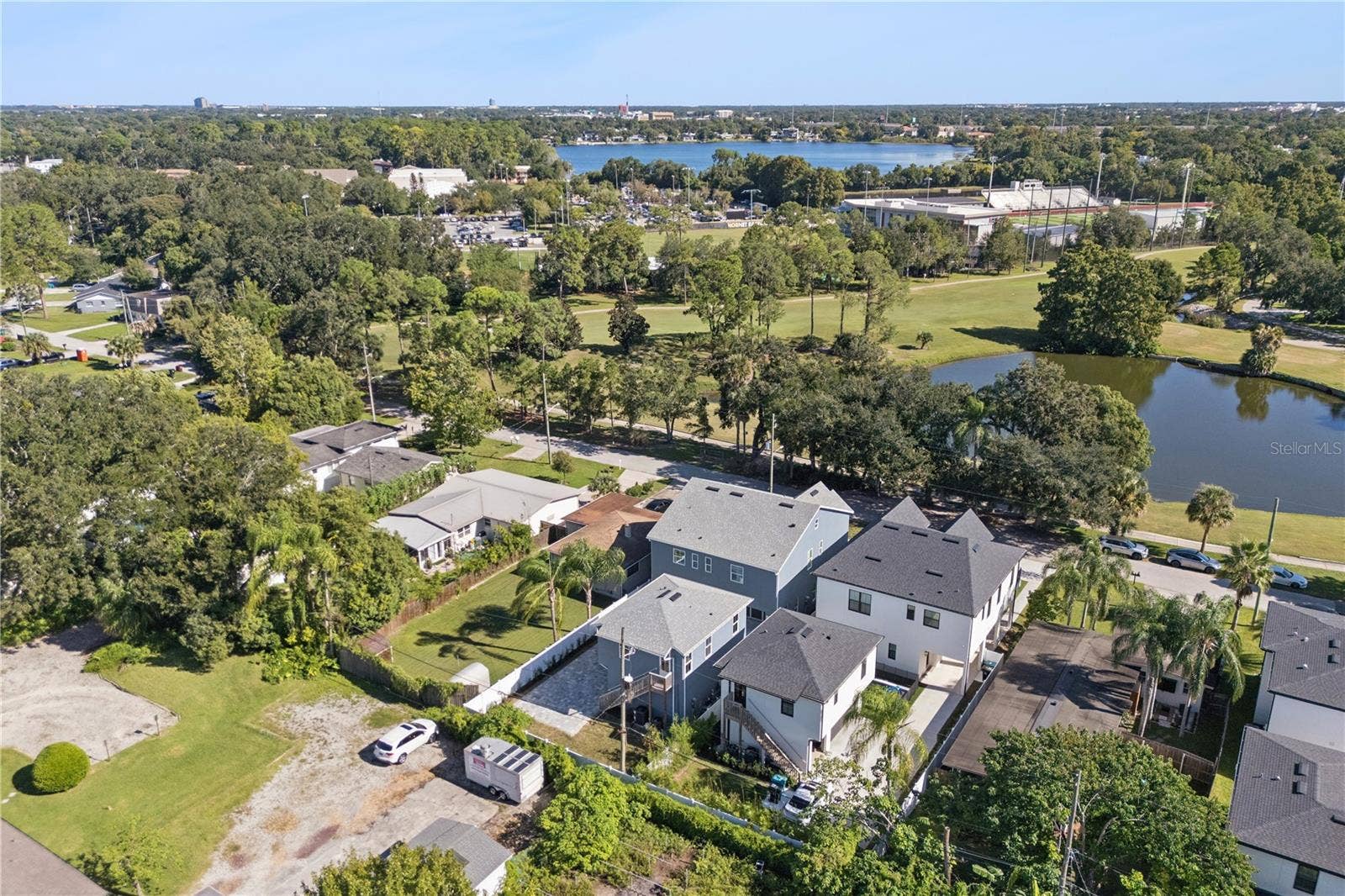 3456 FAIRWAY LANE, Orlando, FL 32804 An aerial view shows the home and surrounding neighborhood, with the golf course and pond across the street.