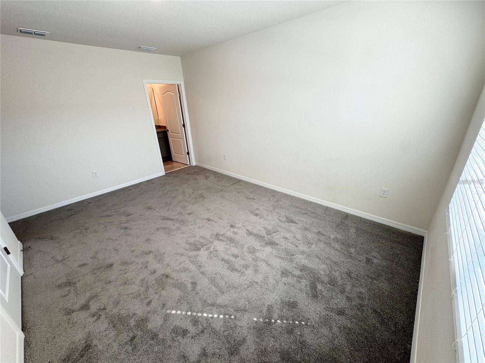 View of primary bedroom toward primary bathroom.