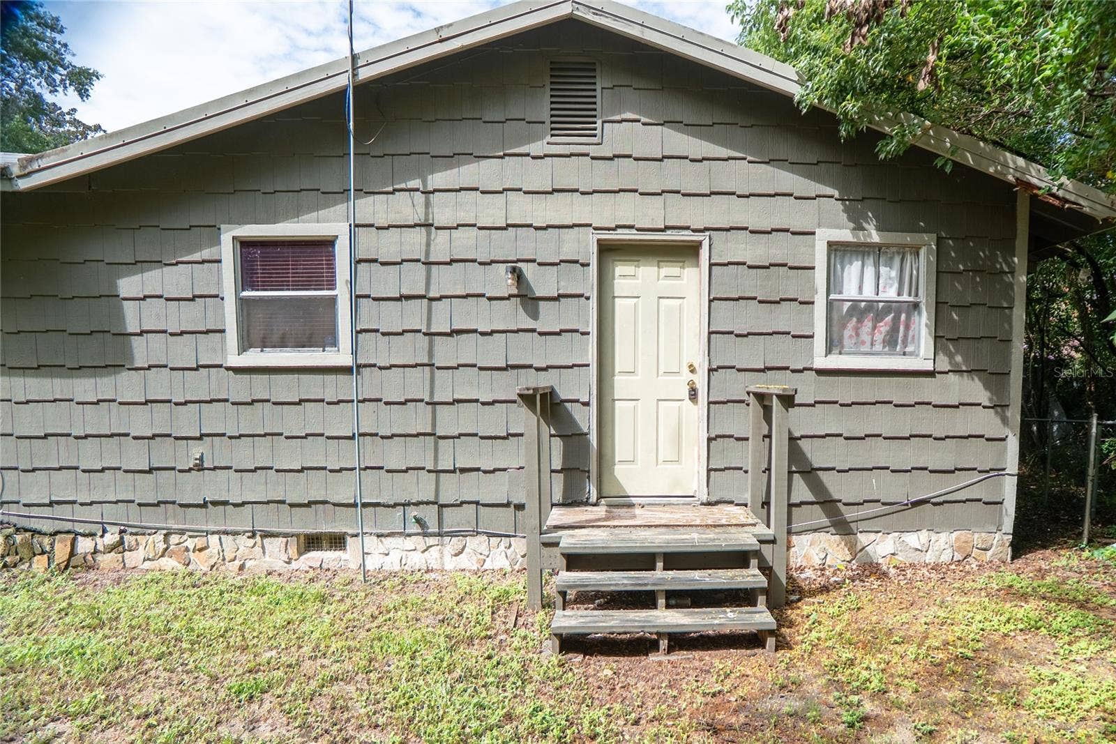 Rear entrance at 311 S Thompson Avenue, DeLand, FL 32720. Rear stairs need repair; do not use.
