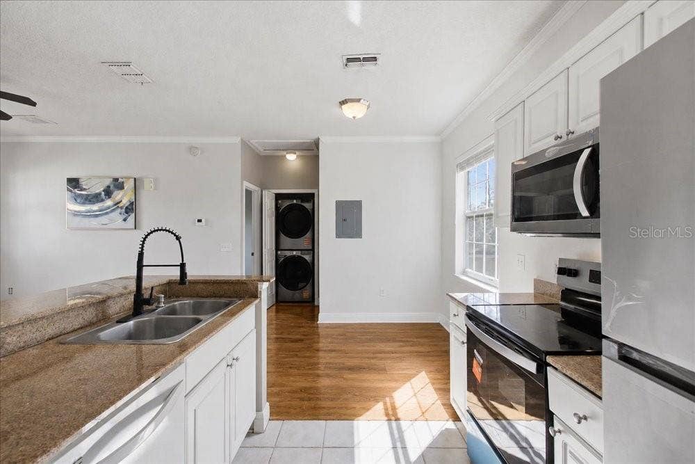 341 SOUTHERN PECAN CIRCLE, #202, Winter Garden, FL 34787 Appliances, counters, and laundry area.