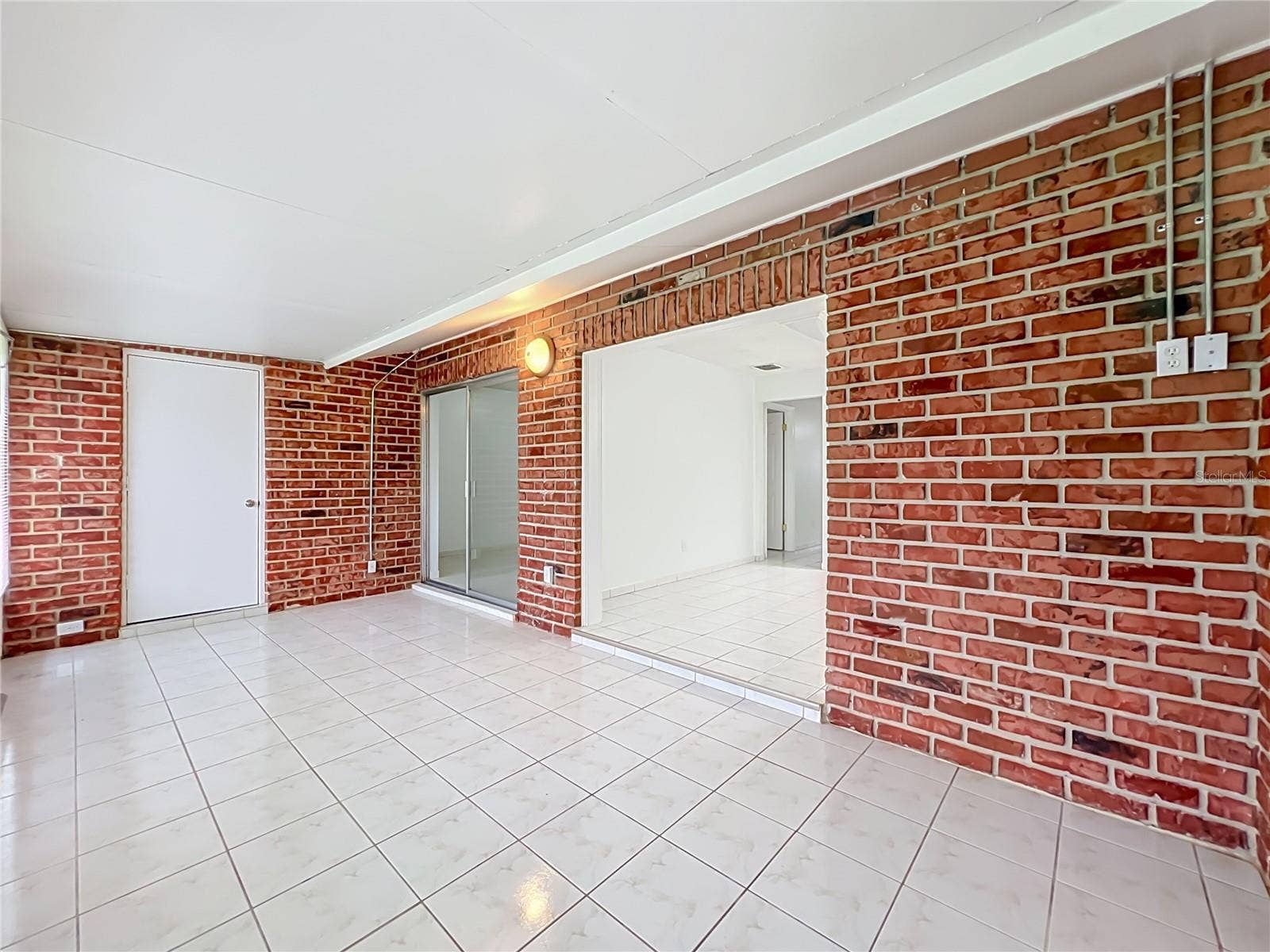 1225 CARRIAGE LANE, #1, Orlando, FL 32807 One of the home's highlights a spacious Florida room offering endless possibilities.