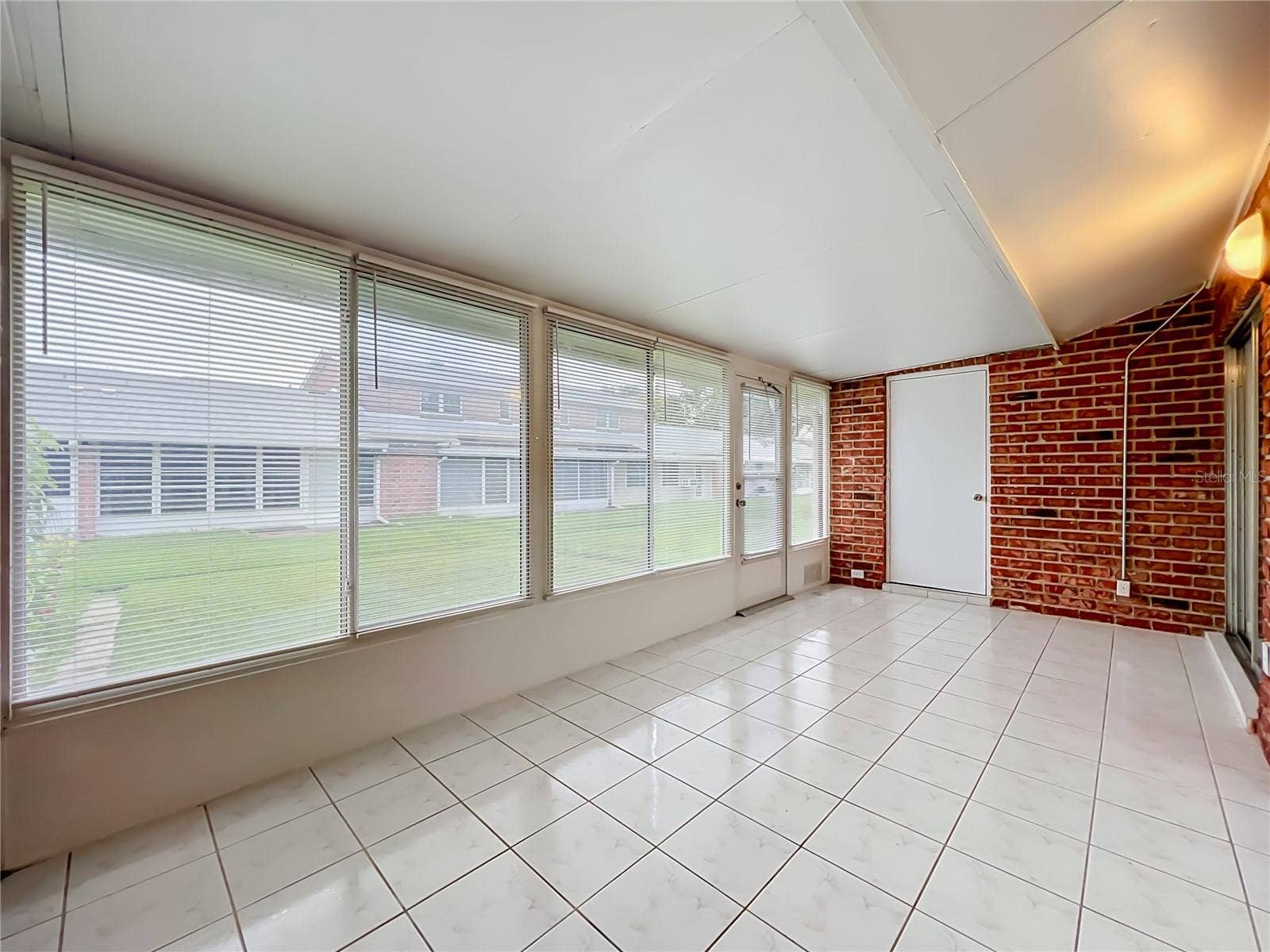 1225 CARRIAGE LANE, #1, Orlando, FL 32807 Florida room connects conveniently to the main living area and kitchen.