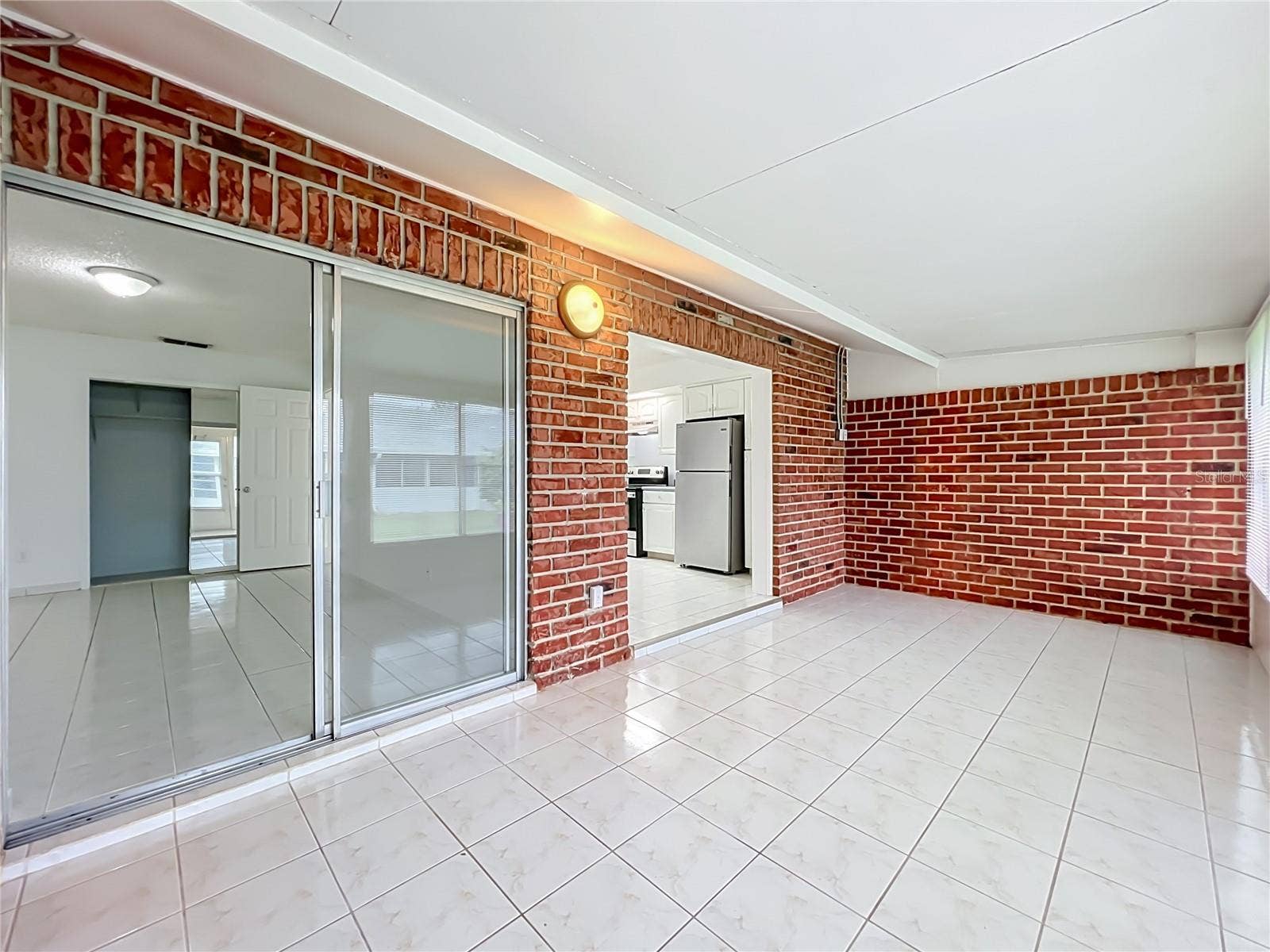 1225 CARRIAGE LANE, #1, Orlando, FL 32807 Generous Florida room provides even more space to spread out and make your own.
