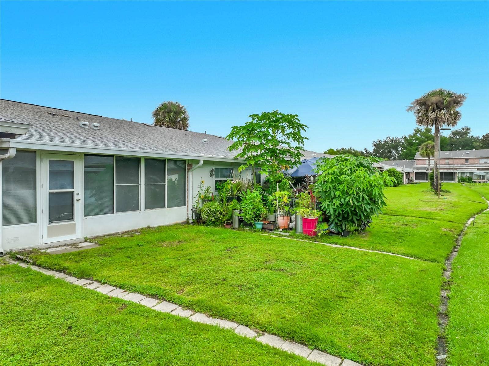 1225 CARRIAGE LANE, #1, Orlando, FL 32807 Green space just outside the home adds to the open and peaceful setting.