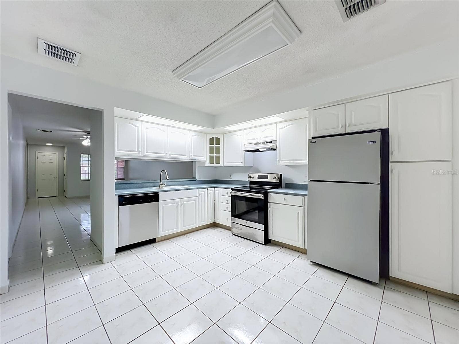 1225 CARRIAGE LANE, #1, Orlando, FL 32807 Spacious kitchen with plenty of cabinet and countertop space for everyday living.