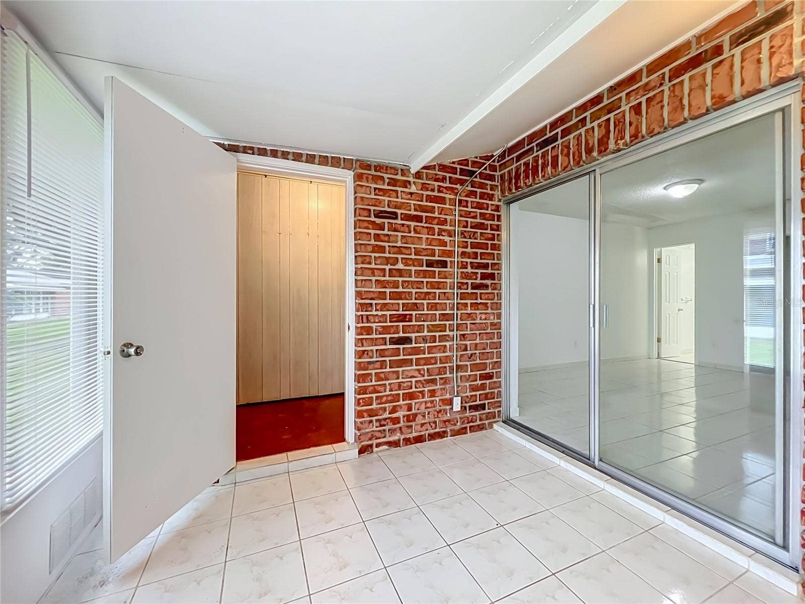 1225 CARRIAGE LANE, #1, Orlando, FL 32807 Enclosed Florida room adds valuable flexible space to enjoy year-round.
