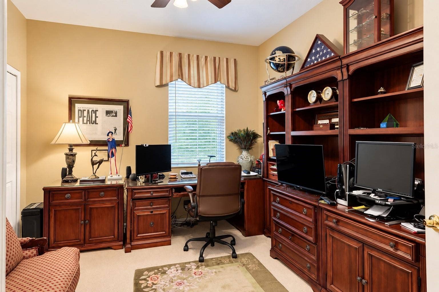 SPACIOUS AND VERSATILE DOWNSTAIRS BEDROOM CURRENTLY BEING USED AS A HOME OFFICE! Featuring abundant natural light, a ceiling fan, and plenty of room for a comfortable workspace. The BUILT-IN CLOSET HAS BEEN CUSTOMIZED INTO A WINE CLOSET, adding a unique touch to this flexible space. Whether used as a HOME OFFICE, GUEST BEDROOM, OR PRIVATE RETREAT, this room offers endless possibilities to suit your lifestyle!
