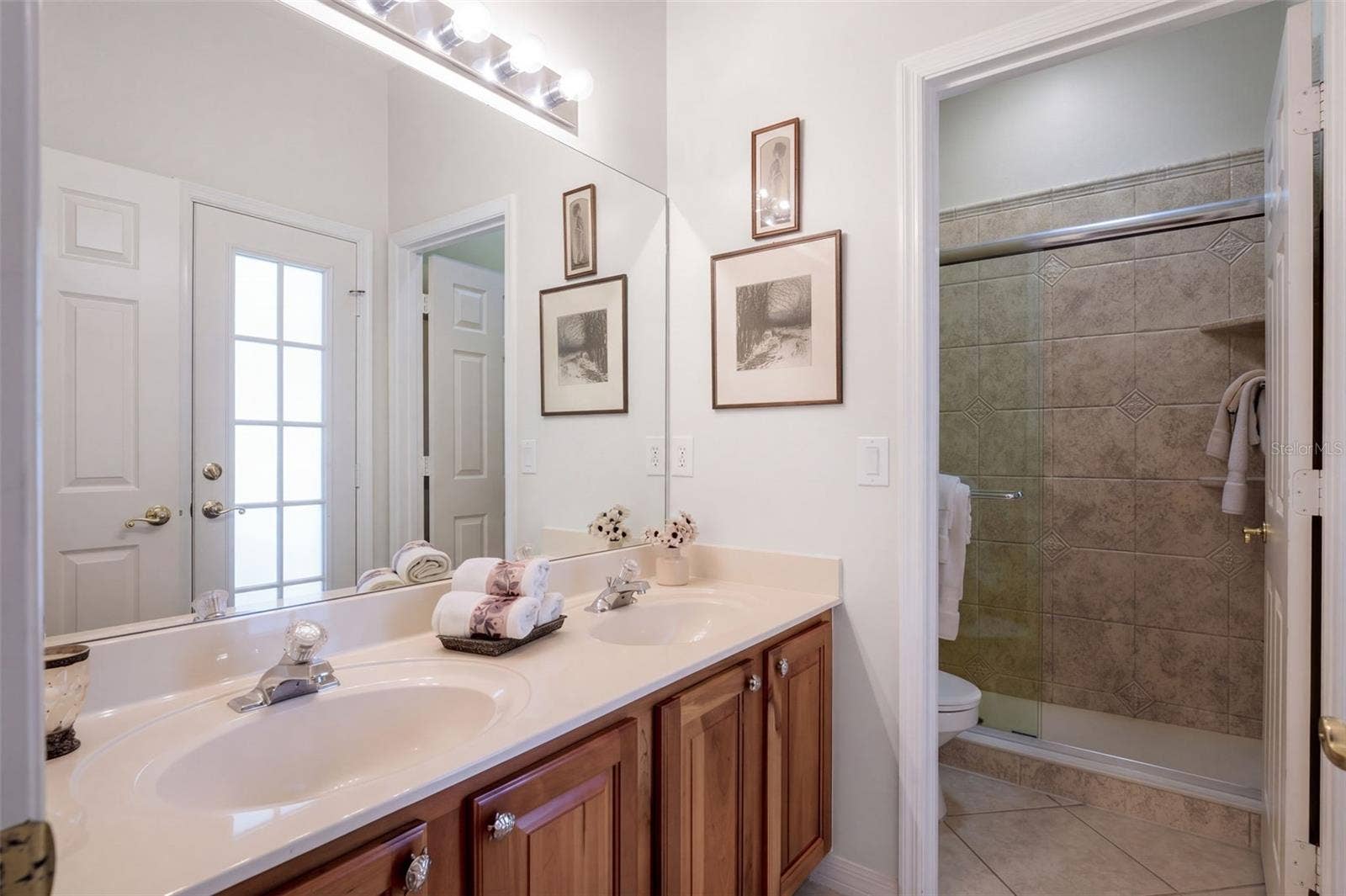 THIRD DOWNSTAIRS BATHROOM CONVENIENTLY LOCATED FOR EASY ACCESS FROM THE POOL AREA!