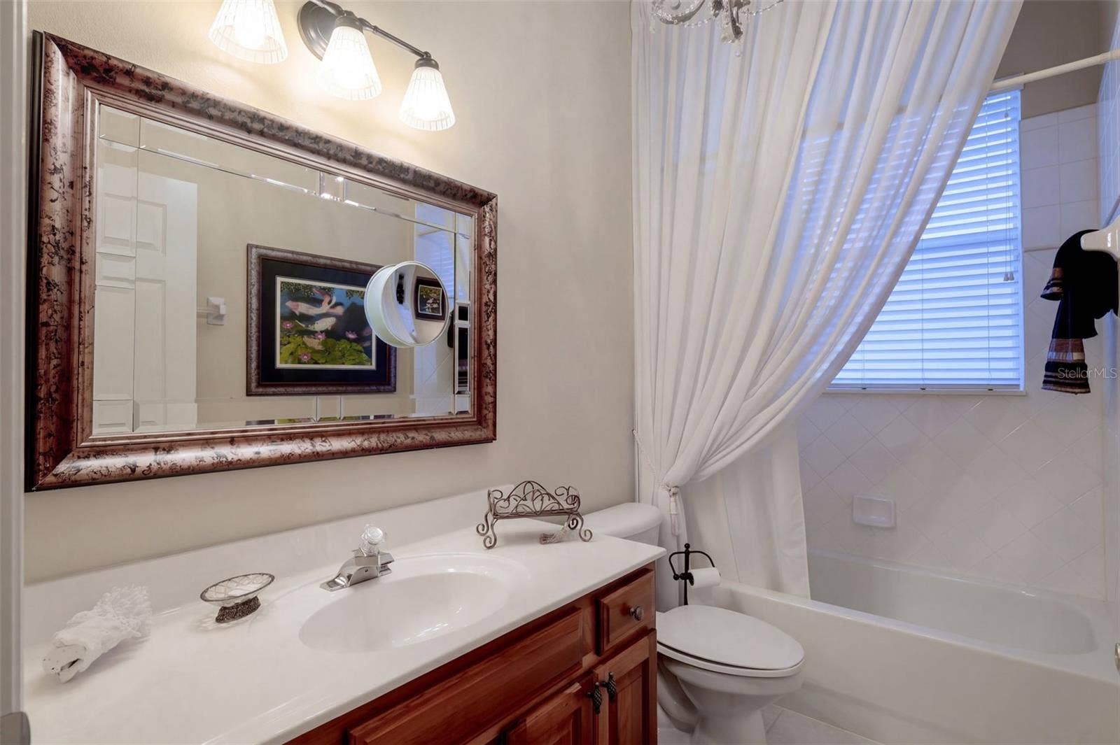 CONVENIENTLY LOCATED SECOND DOWNSTAIRS BATHROOM FEATURING A SPACIOUS VANITY AND TUB/SHOWER COMBINATION!