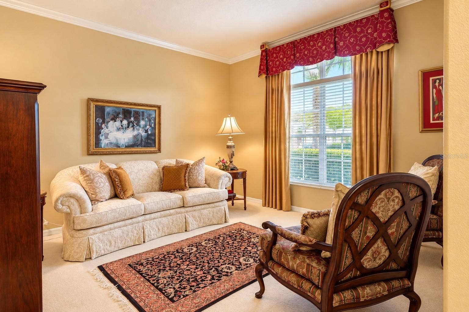 BEAUTIFUL AND INVITING FORMAL LIVING ROOM FEATURING ELEGANT CROWN MOLDING, HIGH CEILINGS, AND A LARGE WINDOW THAT FILLS THE SPACE WITH NATURAL LIGHT! This charming room offers the perfect setting for welcoming guests, enjoying quiet conversations, or creating a cozy sitting area to relax and unwind!