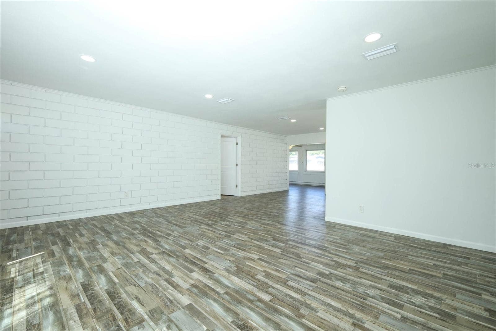 Living room looking into dining and Florida Room.  Look at that brick wall!!