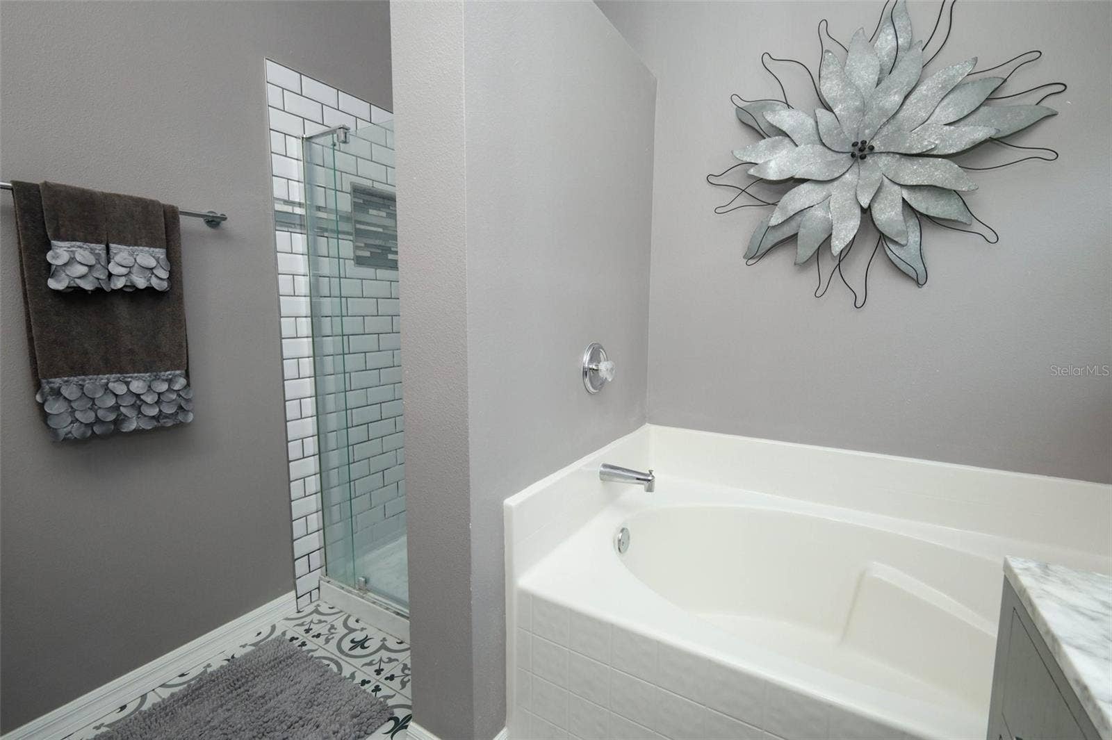 Owners suite bathroom with updated tile and separate soaking tub