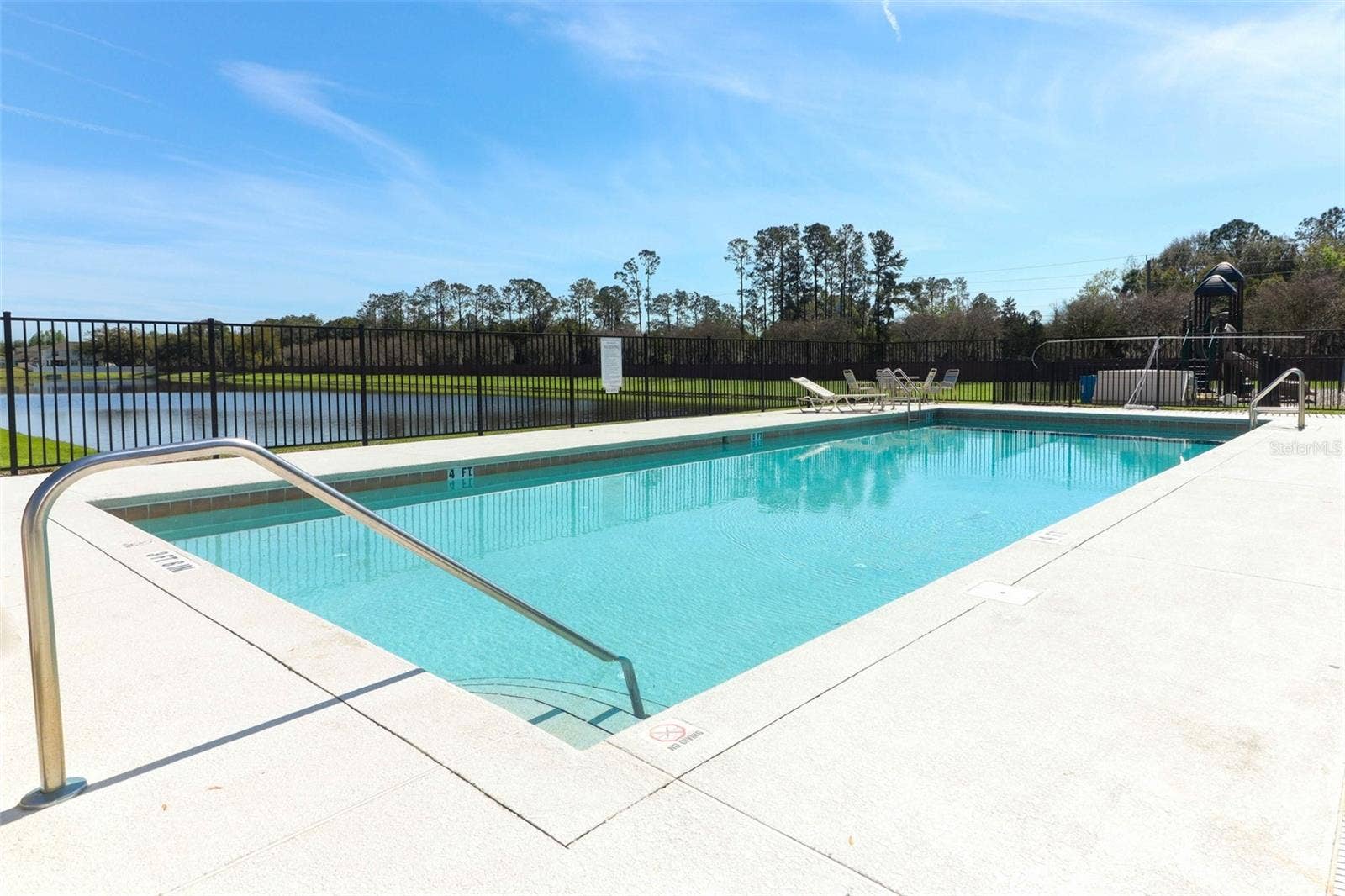 Community pool overlooking a beautiful lake view