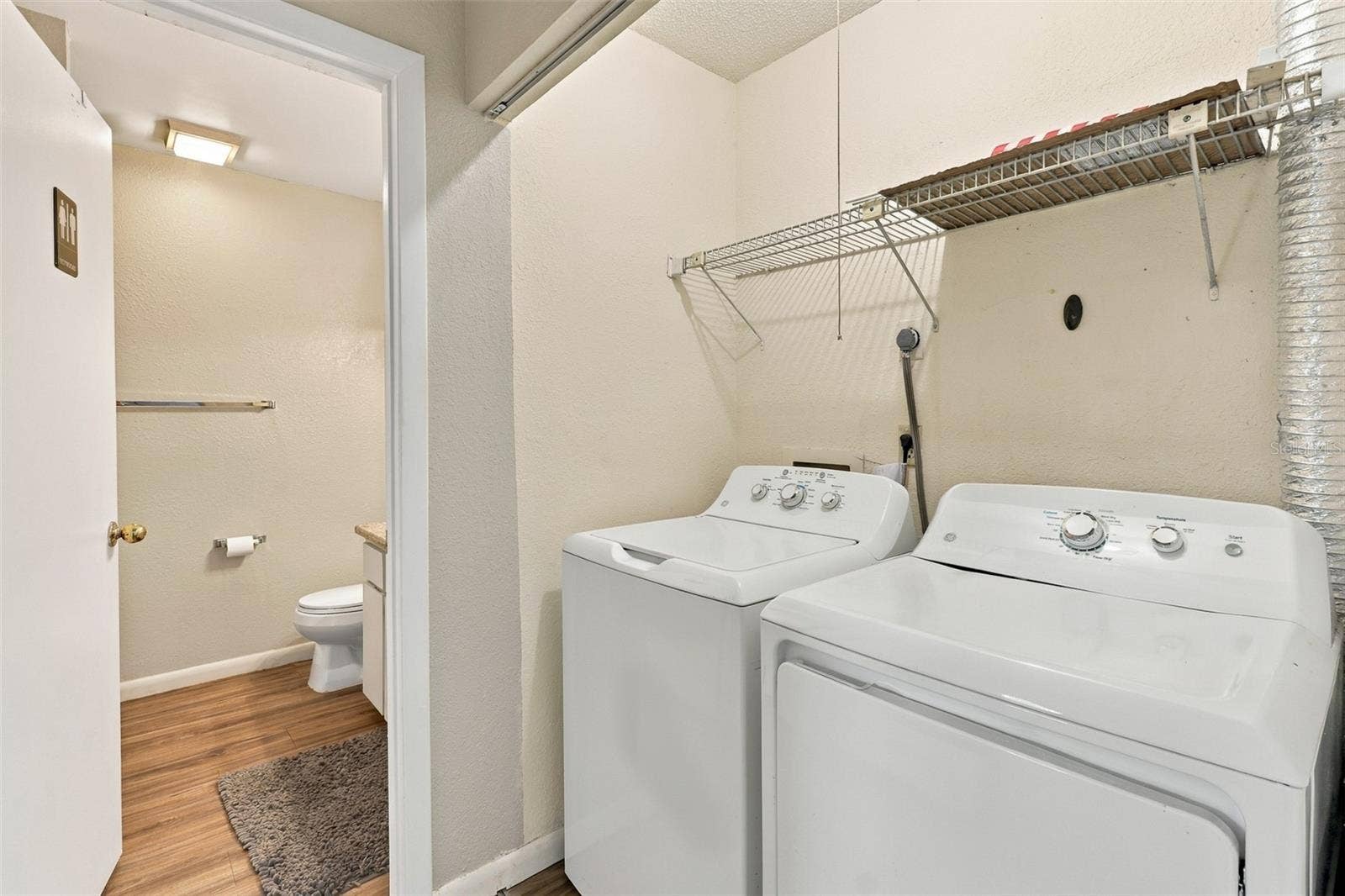 480 LANDING BOULEVARD, Inverness, FL 34450 hallway to guest bath with washer and dryer included