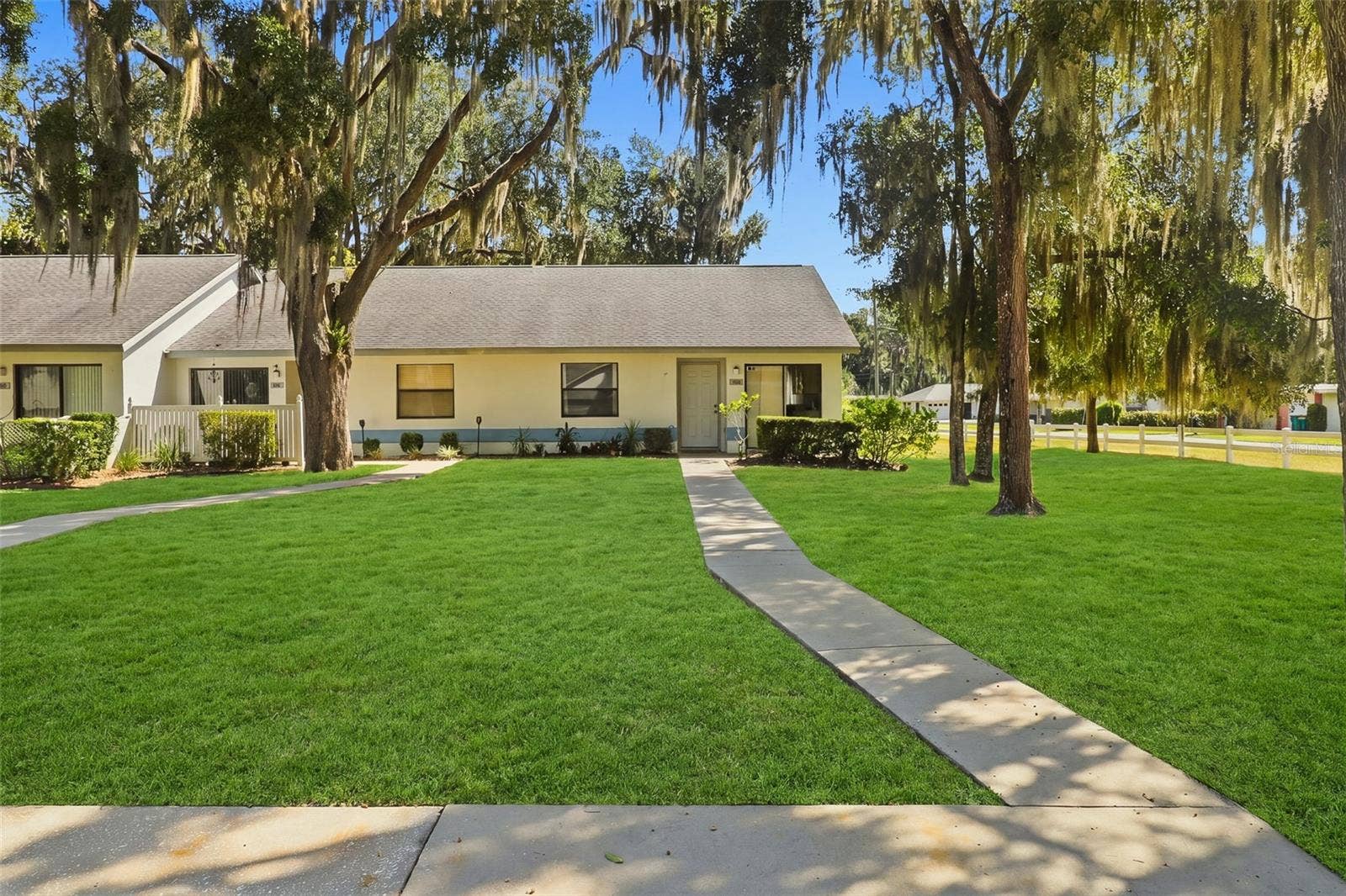 480 LANDING BOULEVARD, Inverness, FL 34450 front view of townhouse and front yard with walk up sidewalk from parking spot