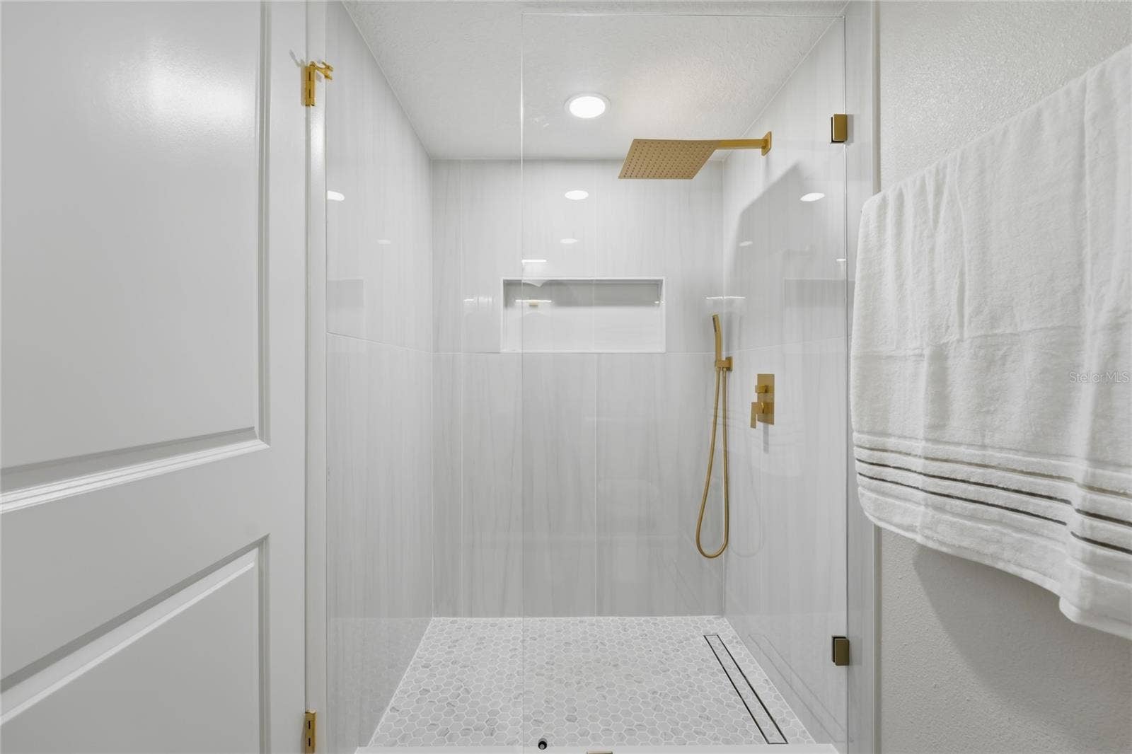 13044 BELLERIVE LANE, Orlando, FL 32828 1st Floor bathroom feautring a stunning porcelain-tiled walk-in shower