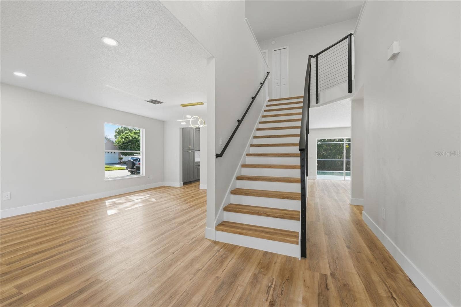 13044 BELLERIVE LANE, Orlando, FL 32828 Entry way showcasing modern cable stair railing