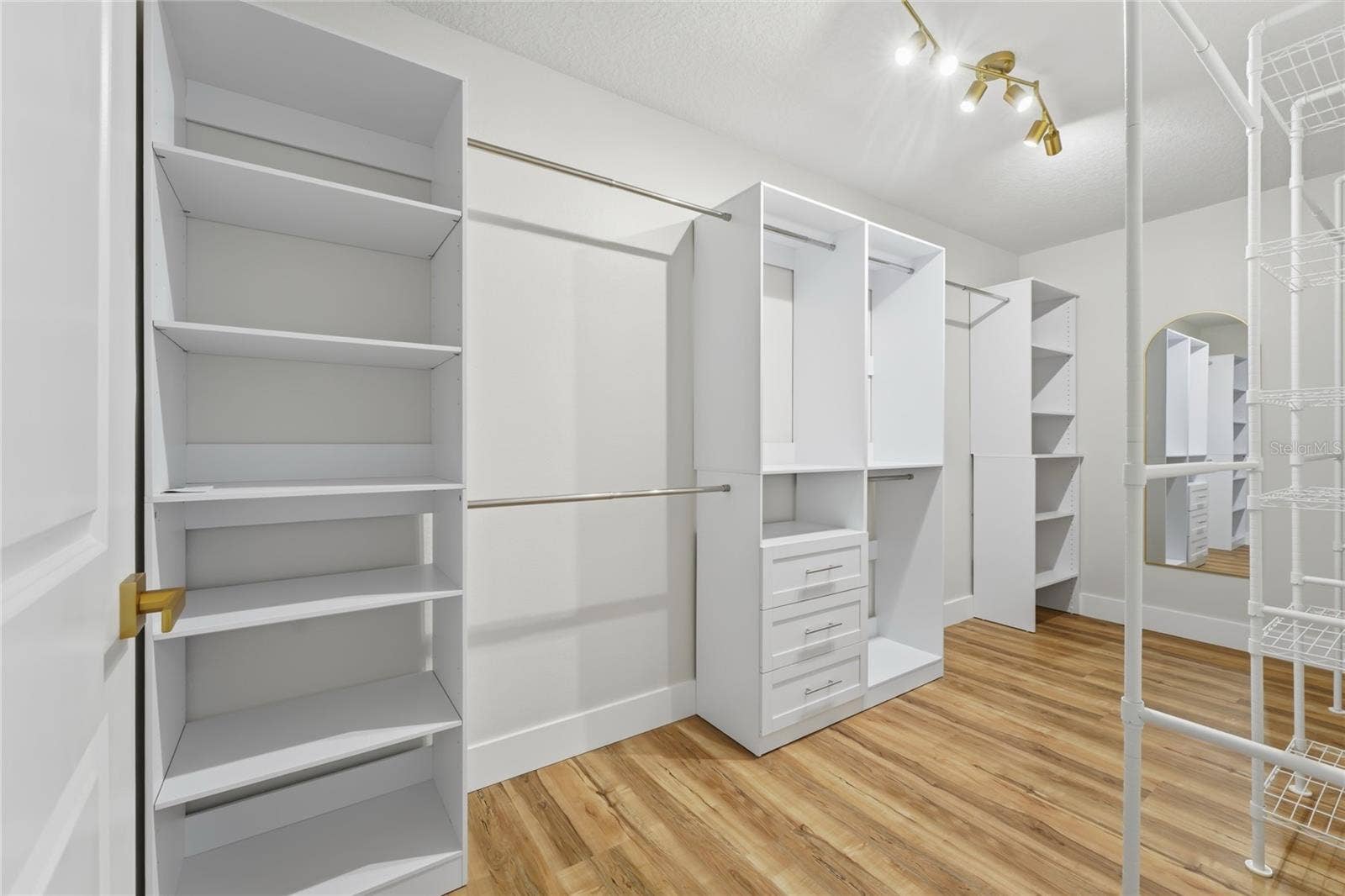 13044 BELLERIVE LANE, Orlando, FL 32828 Master Closet with an organized wardrobe set up