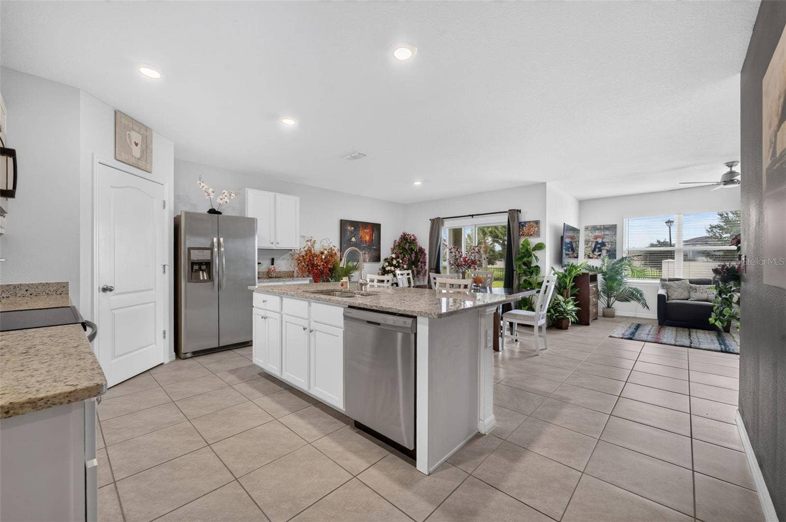 4367 LOOKING GLASS PLACE, Sanford, FL 32771 Open floor plan featuring a spacious kitchen, dining area, and living room.