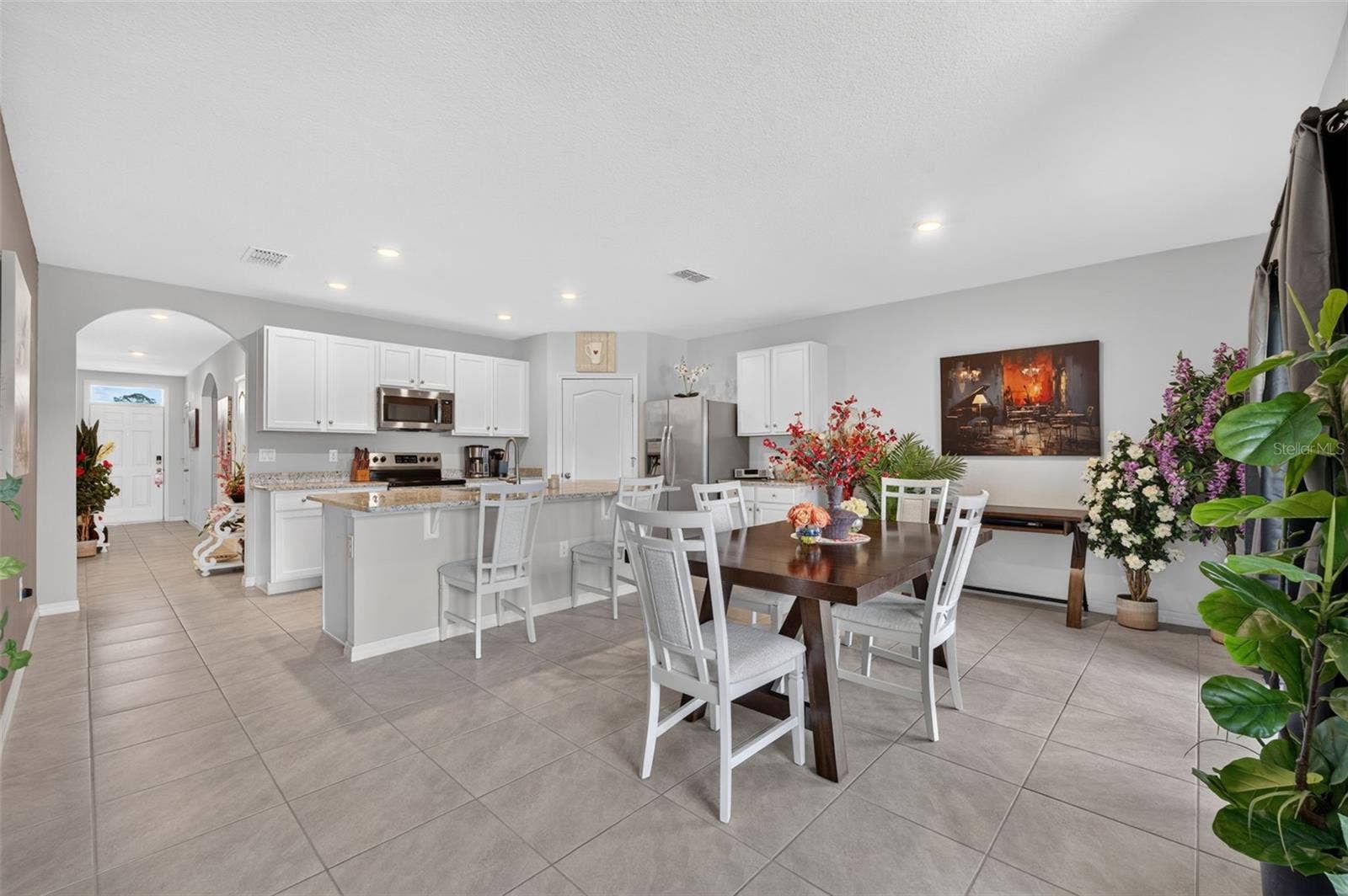 4367 LOOKING GLASS PLACE, Sanford, FL 32771 Open concept floor plan featuring a spacious kitchen and dining area.