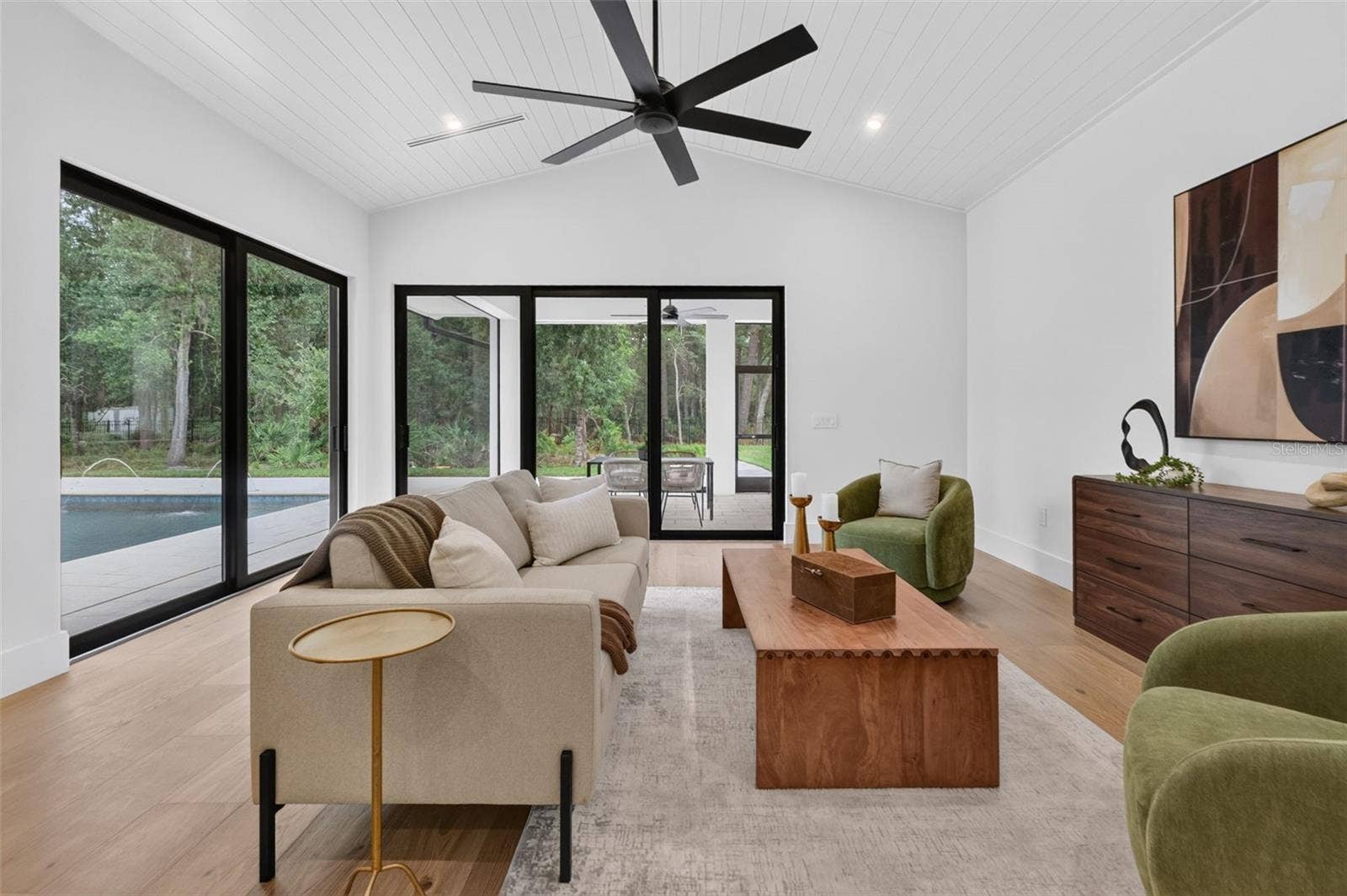 1815 WINDERMERE ROAD, Windermere, FL 34786 Game room features a wet bar with beverage refrigerator and two large sliding glass doors that provide direct access to pool and covered lanai
