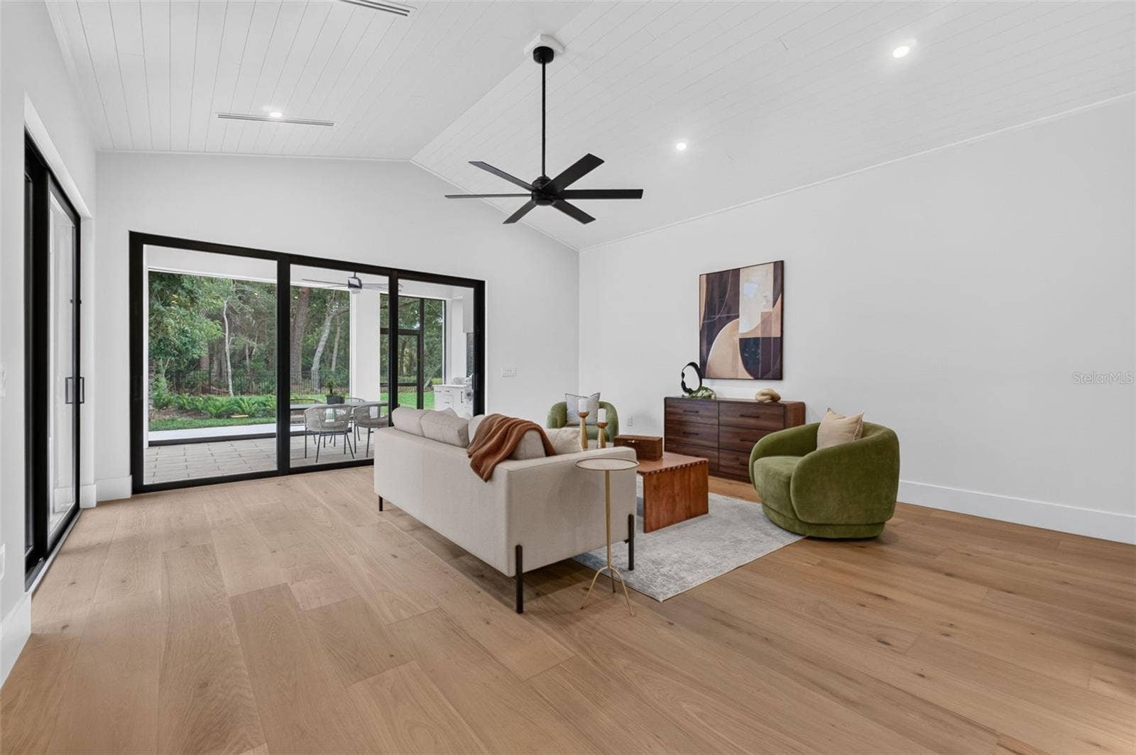 1815 WINDERMERE ROAD, Windermere, FL 34786 Game room features a wet bar with beverage refrigerator and two large sliding glass doors that provide direct access to pool and covered lanai