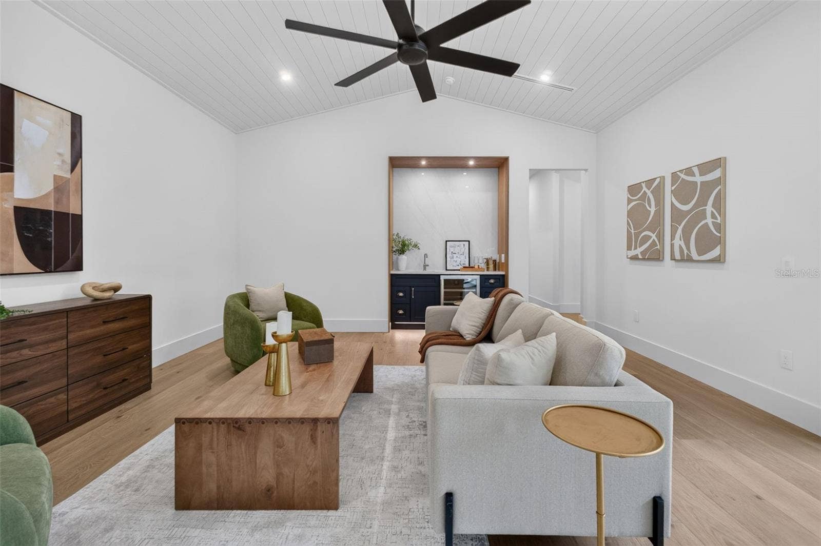 1815 WINDERMERE ROAD, Windermere, FL 34786 Game room features a wet bar with beverage refrigerator and two large sliding glass doors that provide direct access to pool and covered lanai
