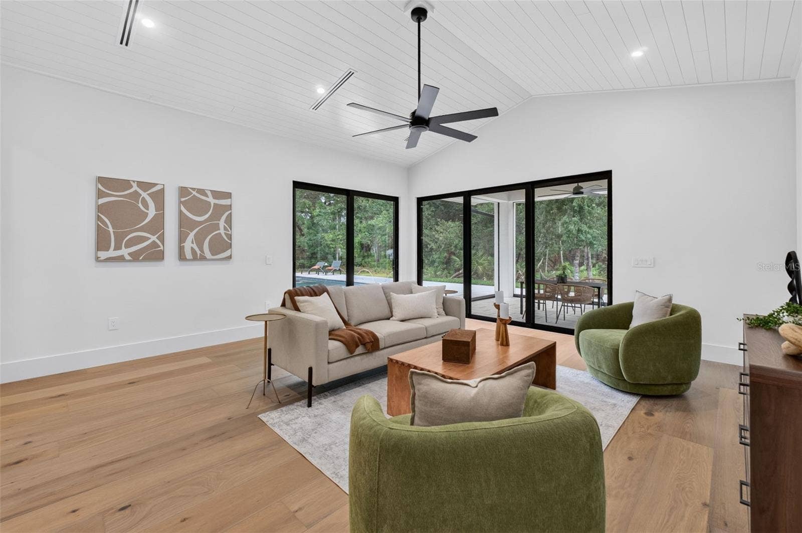 1815 WINDERMERE ROAD, Windermere, FL 34786 Game room features a wet bar with beverage refrigerator and two large sliding glass doors that provide direct access to pool and covered lanai
